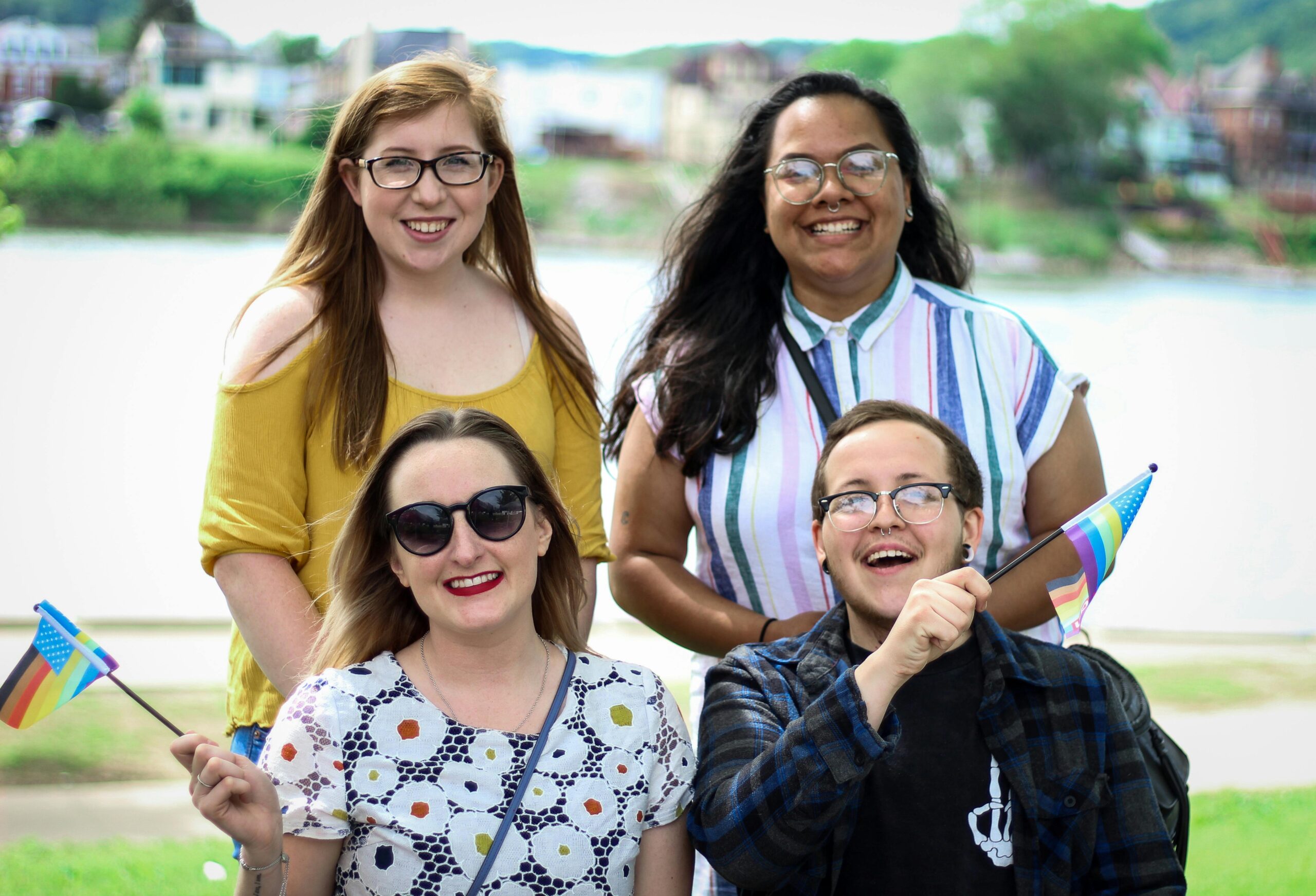 Four diverse friends celebrate at a pride event. Joyful, colorful and symbolic of LGBT pride.